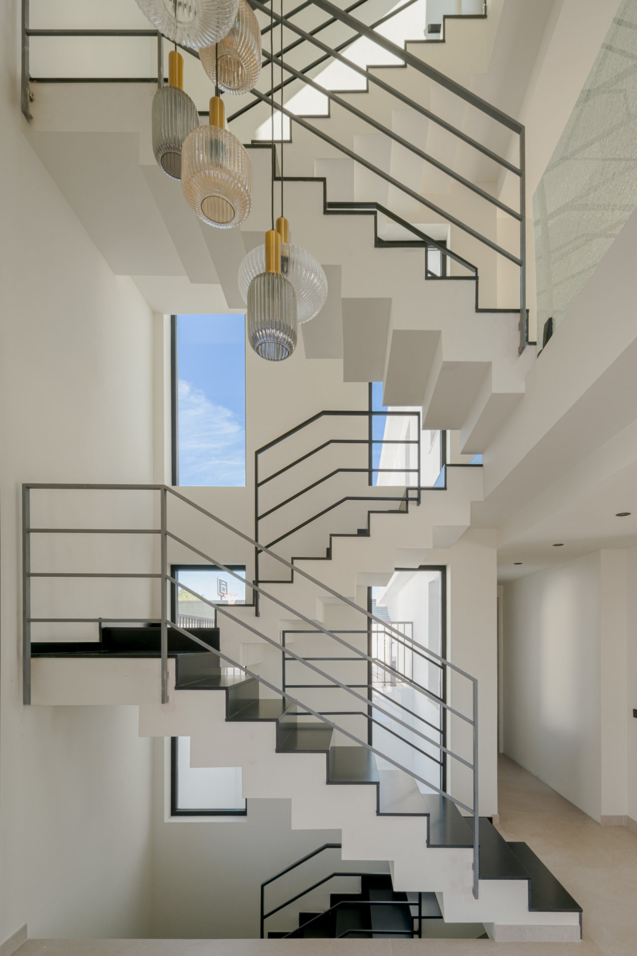 Escalier intérieur métallique sculptural avec suspensions à Villa Venetta · maison individuelle contemporaine à Cártama (Málaga) · Klic Arquitectos