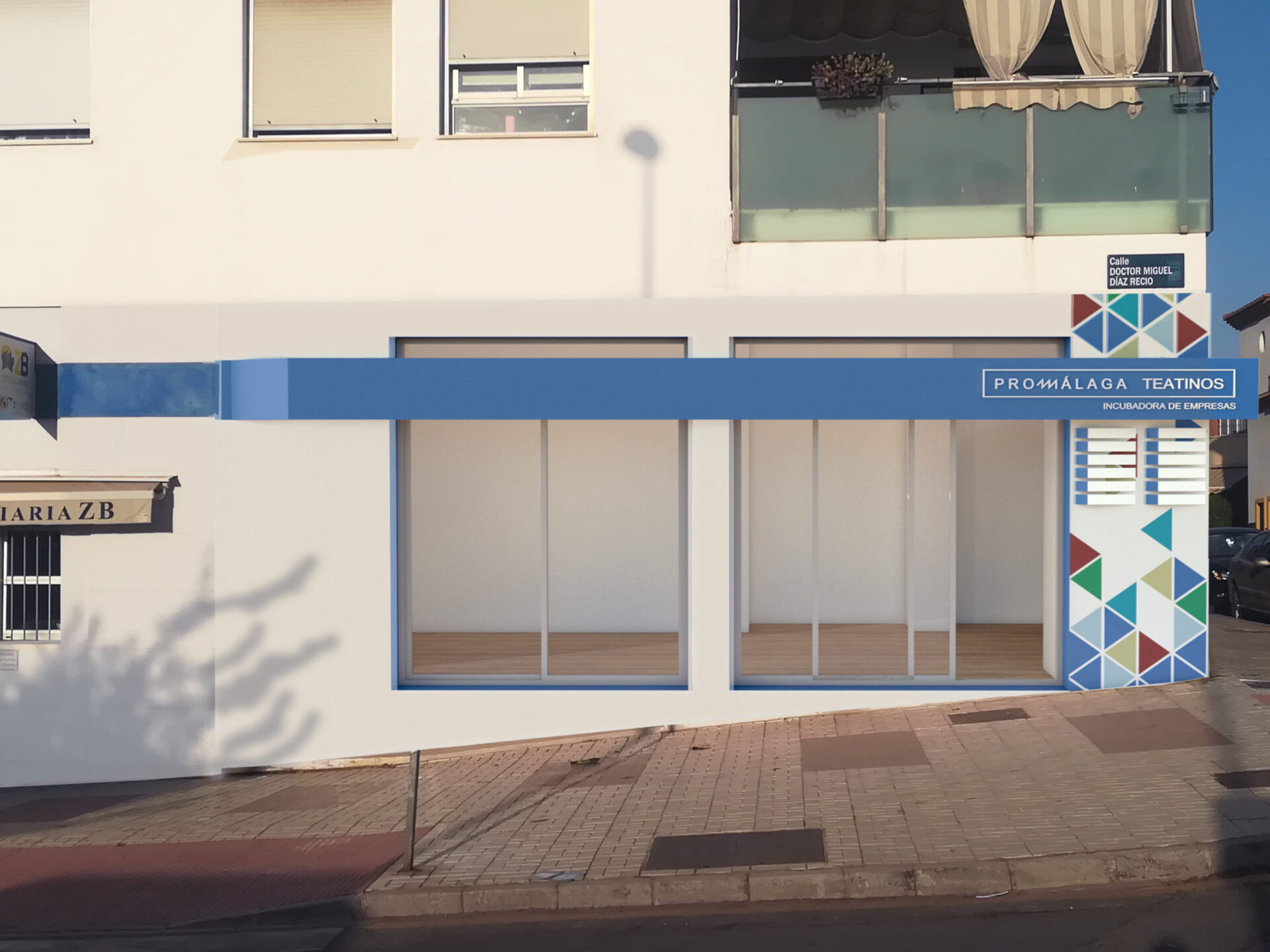 Vorheriges Rendering der Fassade der Büros PROMÁLAGA Teatinos in Málaga mit blauem Corporate-Band, Schild Incubadora de Empresas und Dreiecksmosaik von Klic Arquitectos
