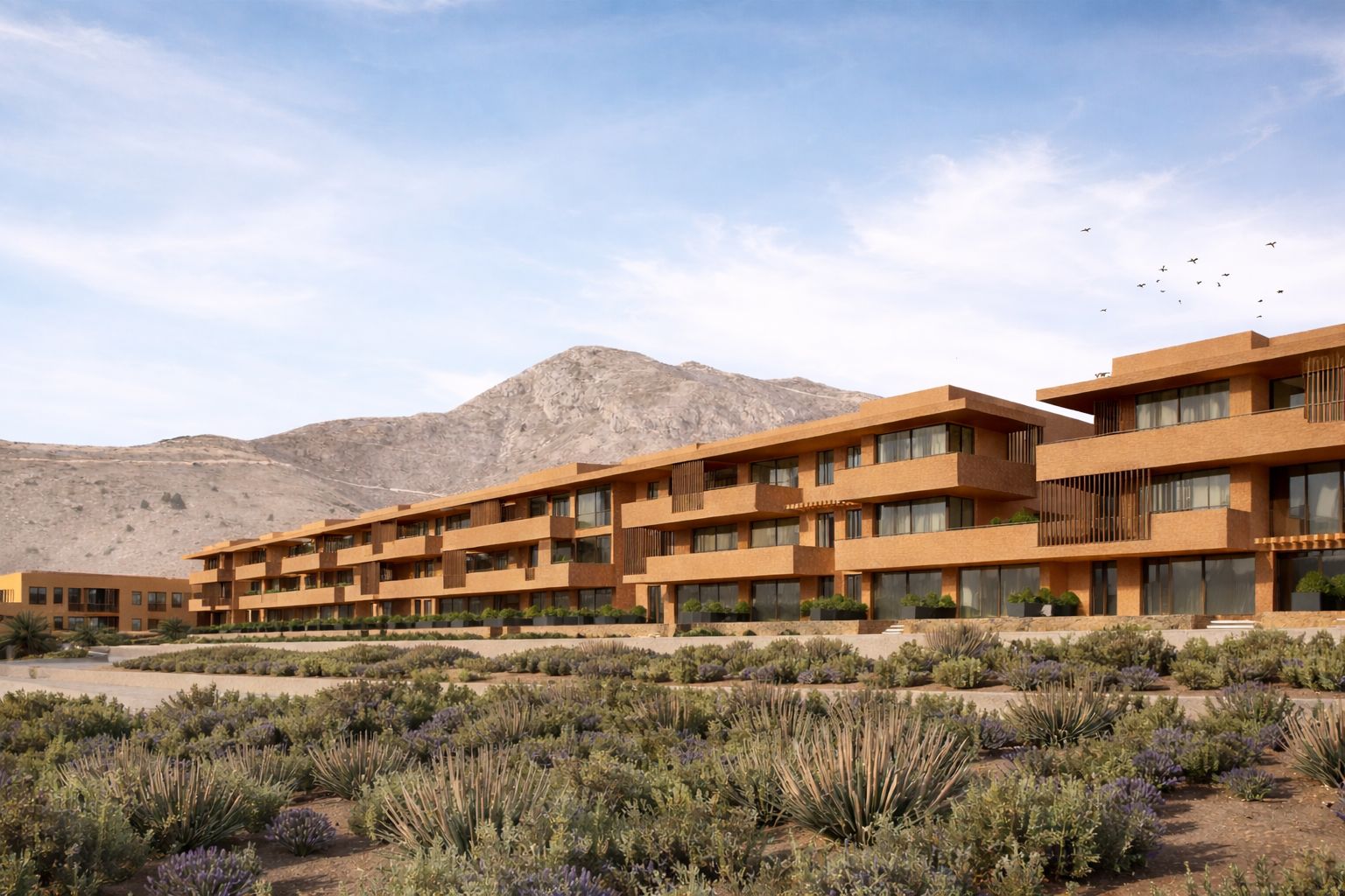 Vista lateral del Edificio Terra con paisaje montañoso del entorno de Santangelo (Benalmádena, Málaga), arquitectura plurifamiliar por Klic Arquitectos