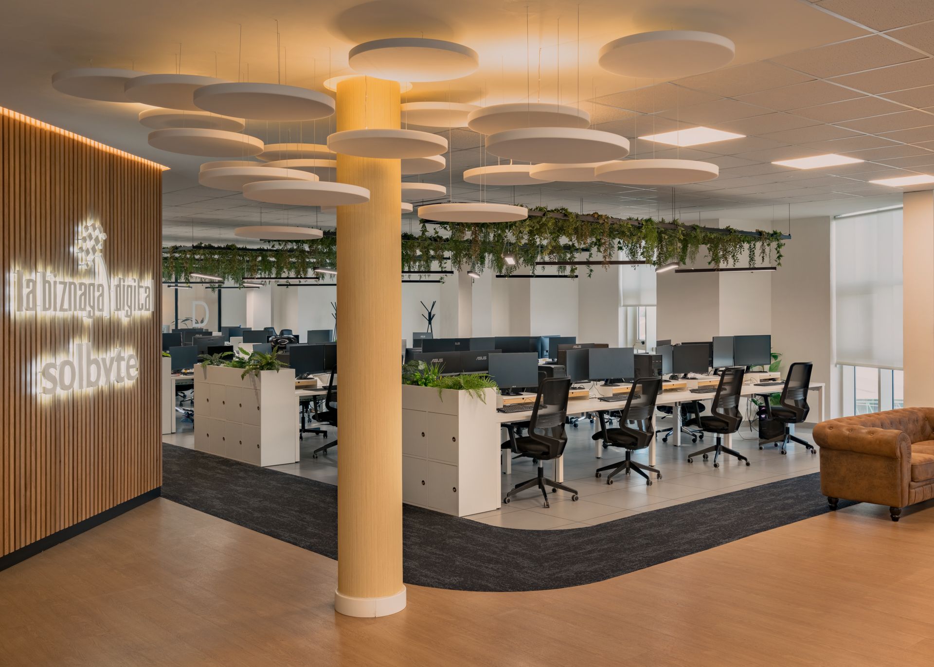 Open space con columna retroiluminada de marca · oficinas Solbyte en el Polígono Industrial Guadalhorce, Málaga · diseño de Klic Arquitectos